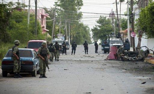 Soldados y policías mexicanos aislan el área en el que se produjo la explosión este viernes de un coche bomba