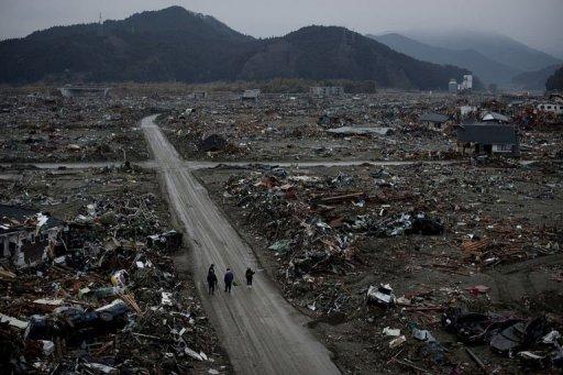 Residentes caminan entre los escombros en la devastada ciudad de Rikuzentakata